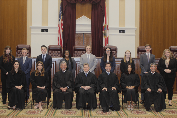 Students stand behind the justices of the Florida Supreme Court.