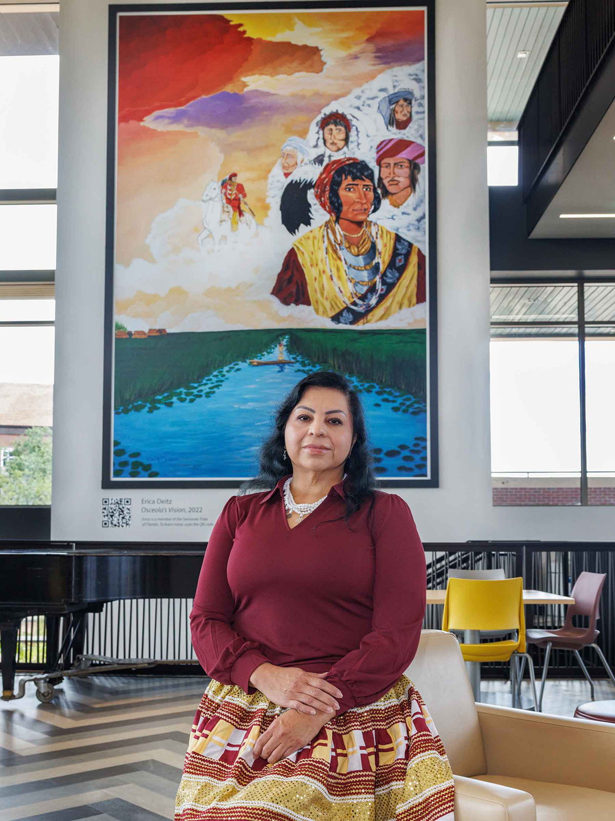 Artist and Seminole Tribe member Erica Deitz with her mural Osceola's Vision in the FSU Student Union