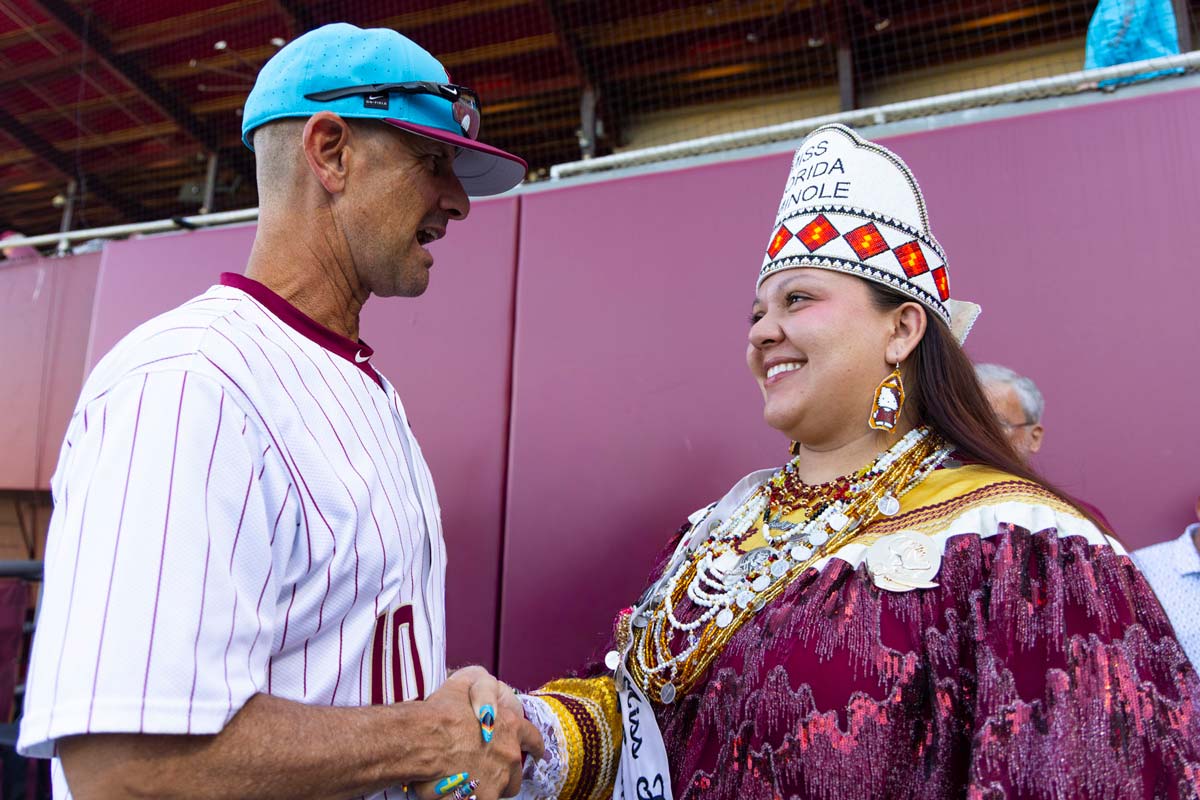 Miss Florida Seminole Bailey Marie Latchford speaking with FSU head coach Link Jarrett before the Seminole Heritage game