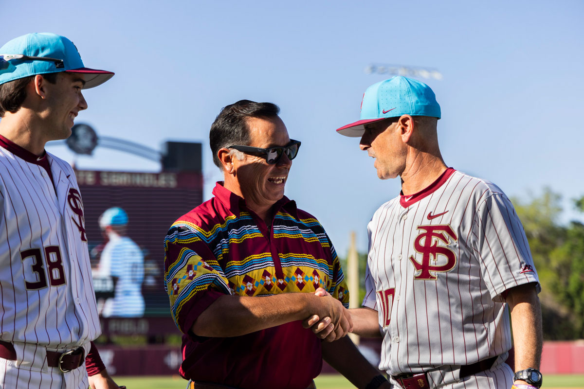 Seminole Tribe Chairman Marcellus Osceola Jr. speaking with FSU head coach Link Jarrett at the Seminole Heritage game