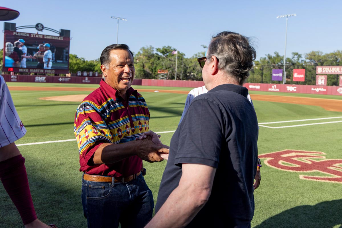 Seminole Tribe Chairman Marcellus Osceola Jr. speaking with FSU President Richard McCullough at the Seminole Heritage game