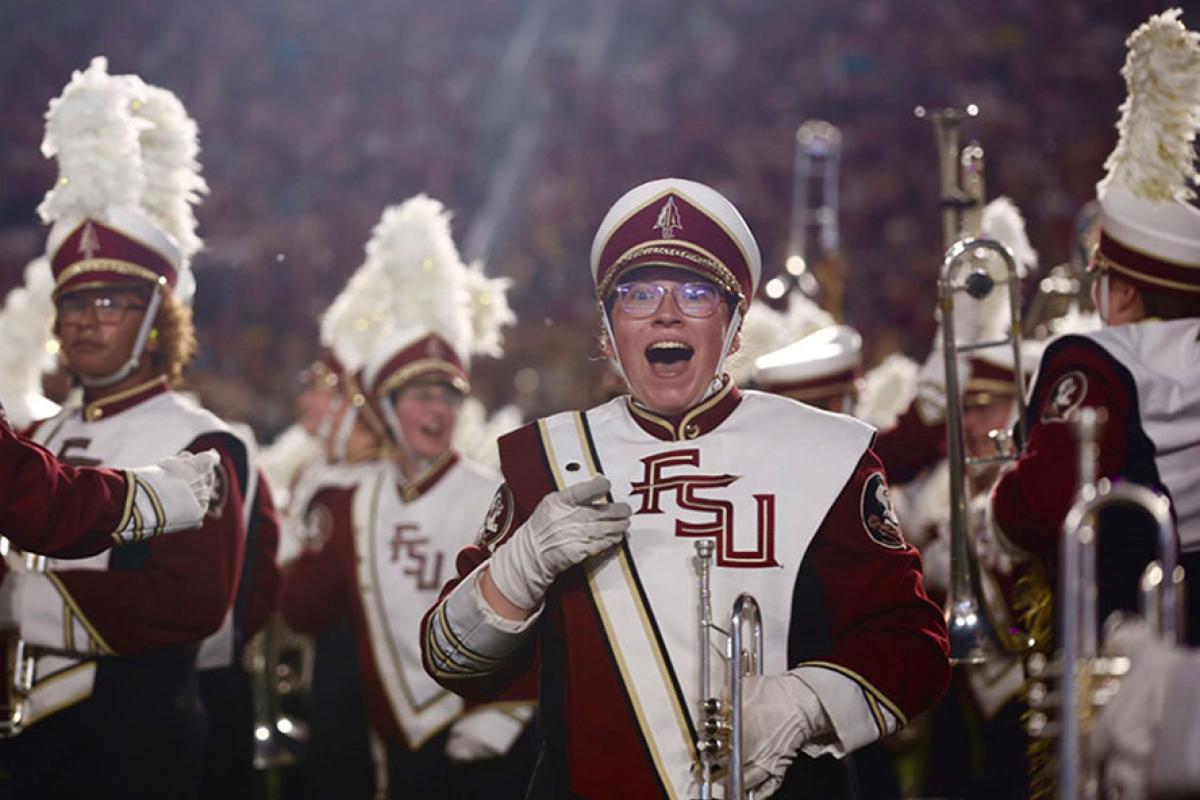 A member of the FSU Marching Chief reacts with an open-mouth smile after hearing the band will perform in the 2027 Macy's Thanksgiving Day Parade.