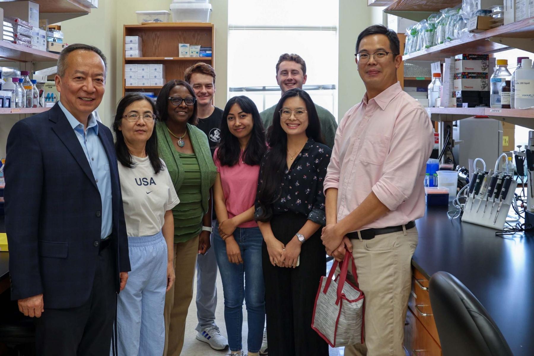 Members of the Irianto Lab and FSU College of Medicine leadership pose together in a lab setting.